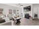 Open living room featuring large windows, a fireplace and hardwood floors at 242 Crestbrook Ln, Dallas, GA 30157