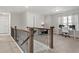Open loft area featuring a staircase, natural light, and flexible space for a home office or study at 242 Crestbrook Ln, Dallas, GA 30157