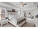 Spacious main bedroom featuring a ceiling fan, dresser, and natural light at 242 Crestbrook Ln, Dallas, GA 30157