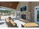 Inviting outdoor living space with stone fireplace and cozy lounge furniture at 242 Crestbrook Ln, Dallas, GA 30157