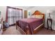 Bedroom featuring a large bed, neutral walls, wood furniture, and a large window at 3319 Colony Dr, Conyers, GA 30013