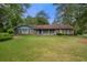 Charming single-story home featuring a well-maintained lawn and mature trees at 3319 Colony Dr, Conyers, GA 30013