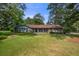 Charming single-story home featuring a well-maintained lawn and mature trees at 3319 Colony Dr, Conyers, GA 30013