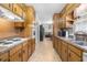 Galley kitchen with long countertops and plenty of cabinet storage at 3319 Colony Dr, Conyers, GA 30013
