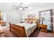 Cozy bedroom featuring wood furniture, ceiling fan, and carpet flooring at 3319 Colony Dr, Conyers, GA 30013