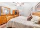 Comfortable main bedroom with ceiling fan, wood furniture, and private bathroom at 3319 Colony Dr, Conyers, GA 30013