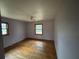 Bedroom features hardwood floors, neutral walls, and windows offering ample natural light at 3450 Estes Dr, Atlanta, GA 30349