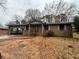 Charming brick home with an attached carport and welcoming front entrance with a small front yard at 3450 Estes Dr, Atlanta, GA 30349