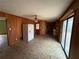 Kitchen view with wood paneling, appliances, and natural light from a sliding glass door at 3450 Estes Dr, Atlanta, GA 30349