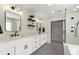 Bright bathroom with double vanity, quartz countertops, sleek black hardware, and modern lighting fixtures at 404 Pinoak Drive Dr, Woodstock, GA 30188