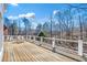 Wide wooden deck features a seating area and beautiful wooded view at 6170 Broadwater Trl, Cumming, GA 30040