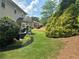 A lovely backyard with a patio and chairs is surrounded by mature landscaping at 200 Edinburgh Ln, Woodstock, GA 30188