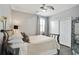 Cozy bedroom with neutral tones, wood floors, a ceiling fan, and a mirrored closet at 200 Edinburgh Ln, Woodstock, GA 30188