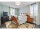 Bedroom with wood floors, a full size bed, side tables, and two windows with curtains at 200 Edinburgh Ln, Woodstock, GA 30188