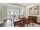 Formal dining room with a large table, elegant chairs, and french doors at 200 Edinburgh Ln, Woodstock, GA 30188