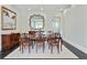 Formal dining room featuring tile flooring and an elegant mirror wall decor feature at 200 Edinburgh Ln, Woodstock, GA 30188