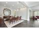 Formal dining room featuring black tile flooring, mirror wall decor, and seating for six guests at 200 Edinburgh Ln, Woodstock, GA 30188