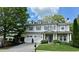 Charming two-story home with a manicured front yard, a three-car garage, and dormer windows at 200 Edinburgh Ln, Woodstock, GA 30188