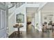 Elegant foyer with slate floors, staircase, statement mirror, and a view into the living spaces at 200 Edinburgh Ln, Woodstock, GA 30188