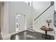 Bright foyer with tile floor, high ceilings, white trim, and staircase at 200 Edinburgh Ln, Woodstock, GA 30188