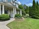 Close up of beautifully landscaped front yard with green grass and brick walkway leading to a stately home at 200 Edinburgh Ln, Woodstock, GA 30188