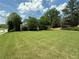 Wide-angle view of front yard and house with lush green lawn and mature landscaping at 200 Edinburgh Ln, Woodstock, GA 30188