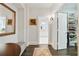 Hallway view showcasing a walk-in closet and bathroom with dark wood flooring at 200 Edinburgh Ln, Woodstock, GA 30188