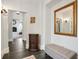 Entryway features a sitting bench, wood floors, and ornate mirror at 200 Edinburgh Ln, Woodstock, GA 30188