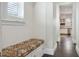 Hallway with built-in bench seating with storage and view into the kitchen at 200 Edinburgh Ln, Woodstock, GA 30188