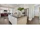 Kitchen island with black countertops, white cabinets, and stainless steel appliances at 200 Edinburgh Ln, Woodstock, GA 30188