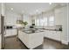 Bright kitchen features a large island, stainless steel appliances, and white cabinets at 200 Edinburgh Ln, Woodstock, GA 30188
