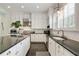Modern kitchen featuring white cabinetry, stainless steel appliances, and granite countertops at 200 Edinburgh Ln, Woodstock, GA 30188