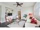Comfortable living room featuring a built-in entertainment center, ceiling fan, and large windows at 200 Edinburgh Ln, Woodstock, GA 30188
