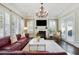 Bright living room with plantation shutters, fireplace, and stylish furnishings at 200 Edinburgh Ln, Woodstock, GA 30188