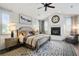 Relaxing main bedroom with fireplace, sitting area, ceiling fan, and large rug at 200 Edinburgh Ln, Woodstock, GA 30188