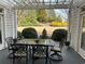 Outdoor patio with large dining table features beautiful landscaping view at 200 Edinburgh Ln, Woodstock, GA 30188