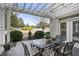 Outdoor patio features a pergola with seating, landscaping and well-manicured backyard at 200 Edinburgh Ln, Woodstock, GA 30188
