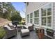 Back patio features outdoor seating, grill, and view of lush landscaping and house at 200 Edinburgh Ln, Woodstock, GA 30188