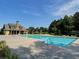 A community pool with a clear blue sky and a large pool house at 200 Edinburgh Ln, Woodstock, GA 30188