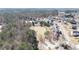 Neighborhood aerial view featuring a pond surrounded by lush trees and single-Gathering homes at 1105 Fountain Head Ln, Lawrenceville, GA 30043