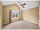 Bedroom featuring vaulted ceiling, ceiling fan, and large picture window at 1105 Fountain Head Ln, Lawrenceville, GA 30043