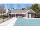 Community covered pool featuring lounge seating and a brick pool house with shade for relaxation at 1105 Fountain Head Ln, Lawrenceville, GA 30043