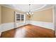 Elegant dining room with hardwood floors, crown molding, and a modern chandelier at 1105 Fountain Head Ln, Lawrenceville, GA 30043