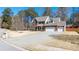 Charming two-story brick home with a well-manicured front yard and a three-car garage at 1105 Fountain Head Ln, Lawrenceville, GA 30043