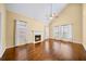 Bright and airy living room with a fireplace, ceiling fan, and gleaming hardwood floors at 1105 Fountain Head Ln, Lawrenceville, GA 30043
