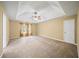 Spacious main bedroom with a tray ceiling, neutral walls and carpet, and a ceiling fan at 1105 Fountain Head Ln, Lawrenceville, GA 30043