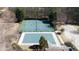 Aerial view of community tennis courts and a covered pool surrounded by lush landscaping at 1105 Fountain Head Ln, Lawrenceville, GA 30043