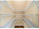 Organized walk-in closet with white wire shelving and ample storage space at 1105 Fountain Head Ln, Lawrenceville, GA 30043