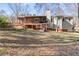 Back exterior featuring a patio, second story porch, and well-maintained yard at 1525 Willow Gate Way, Auburn, GA 30011