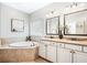 Bathroom features a soaking tub, double sinks, and granite countertops at 3557 Ashcroft Se Dr, Smyrna, GA 30080